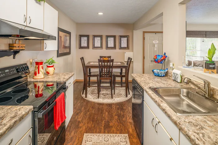 Inviting open kitchen with sleek countertops, modern appliances, and cozy dining area, perfect for entertaining.