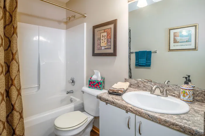 Charming bathroom with elegant decor, featuring a luxurious bathtub, modern sink, and stylish countertop.