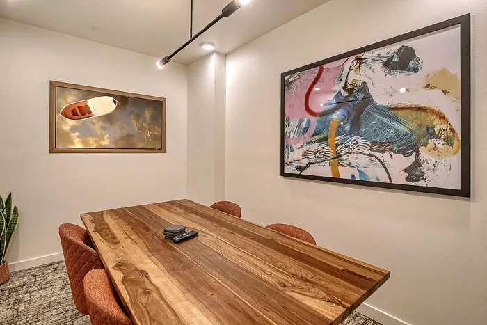 Chic and modern meeting room with stylish wall art and elegant wooden table, ideal for creative brainstorming sessions.