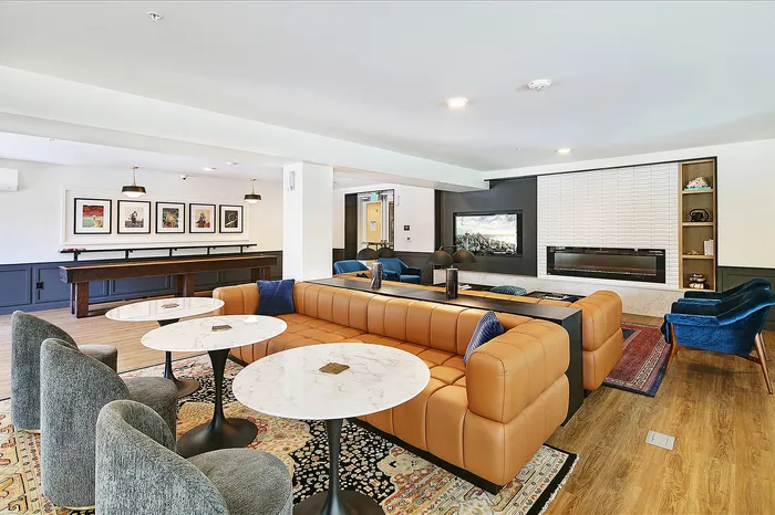 Elegant modern lounge with luxurious leather seating, stylish decor, and a vibrant entertainment area.