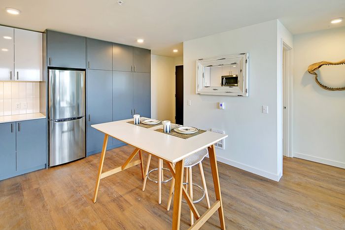 Bright modern kitchen with sleek cabinetry, stainless steel appliances, and a stylish dining area perfect for entertaining.