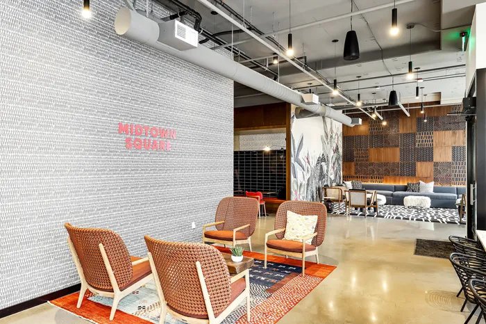 Chic and modern lounge at Midtown Square featuring stylish seating, vibrant wall art, and contemporary lighting.