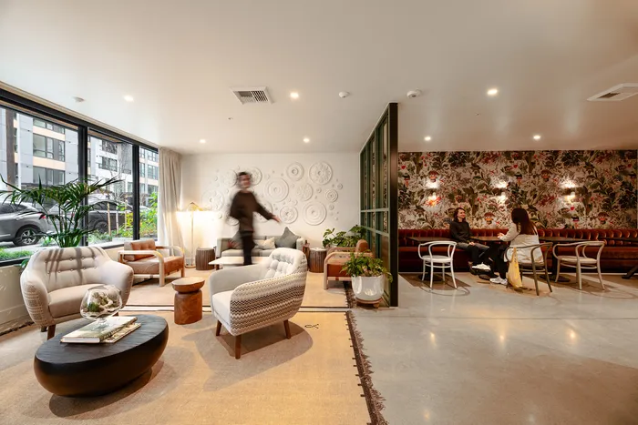 Chic apartment lounge with stylish seating, modern decor, and ambient lighting offering a cozy, contemporary vibe.