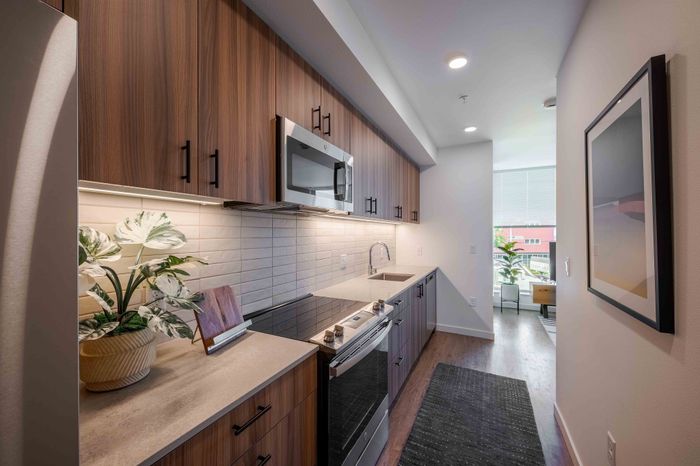 Elegant kitchen with modern wood cabinetry, sleek appliances, and a bright, open layout with natural light.