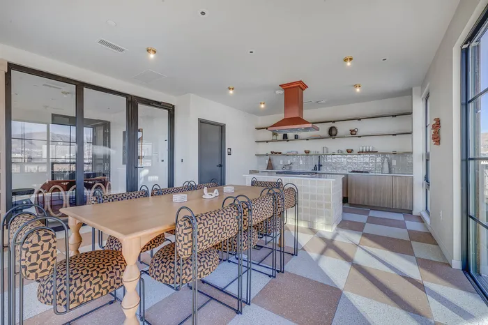 Modern and inviting apartment dining area with open-concept kitchen.