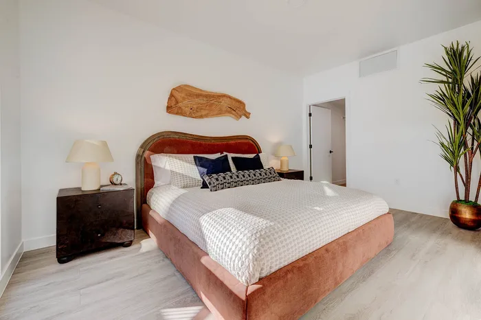 Inviting bedroom with a stylish wood headboard and modern bedside tables.