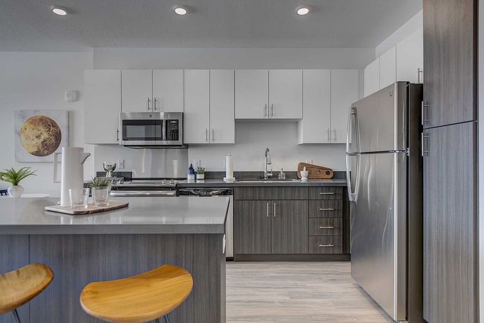Contemporary kitchen with sleek appliances, elegant cabinetry, and a stylish breakfast bar, perfect for modern living.
