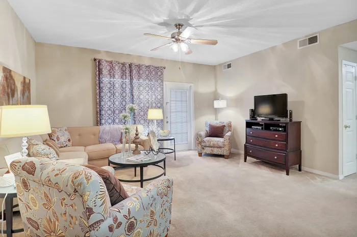 Inviting living room with cozy seating, elegant decor, and natural light filtering through stylish curtains, perfect for relaxation and entertainment.