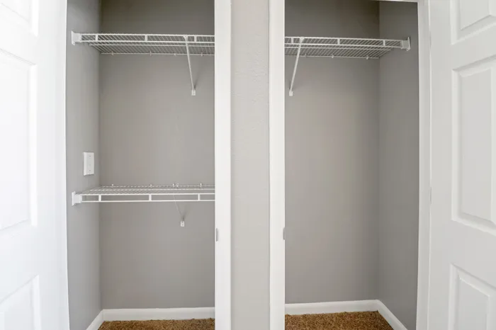 Spacious double-door closet with sleek wire shelving, perfect for organized storage solutions.