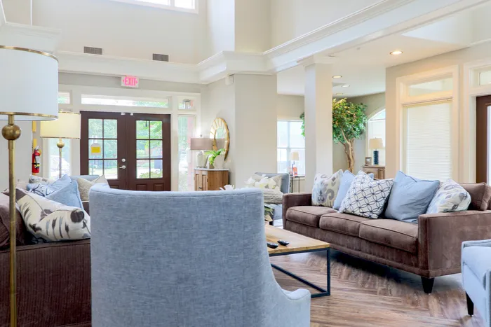 Elegant and airy living room with plush seating, modern decor, and abundant natural light.