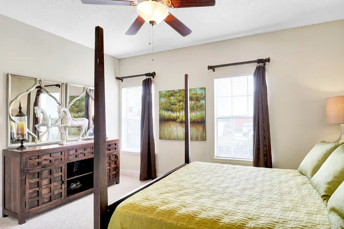 Charming bedroom with unique wooden furniture, elegant wall art, and warm natural lighting creating a cozy ambiance.