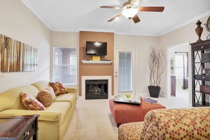 Bright, cozy living room with a modern fireplace, comfortable seating, and stylish decor, perfect for relaxation.