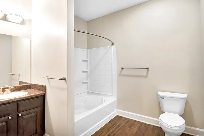 Elegant bathroom featuring a sleek granite countertop vanity, modern fixtures, and a pristine bathtub, offering a serene escape.