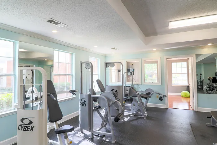 Bright and inviting fitness center featuring CYBEX training equipment and ample natural light.