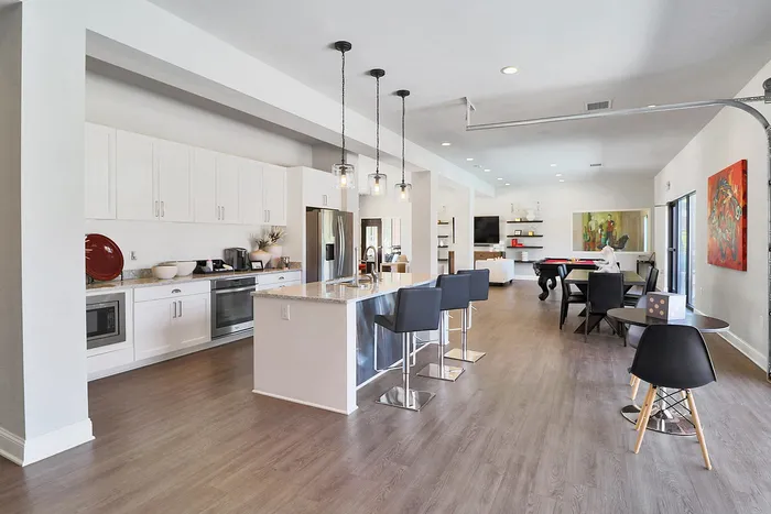 Contemporary open-plan kitchen and living area with sleek design, featuring a stylish island, modern appliances, and elegant dining space.