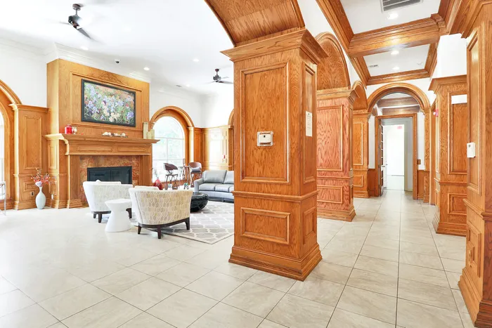 Elegant living space featuring rich wood paneling, a cozy fireplace, and stylish seating area with modern decor.