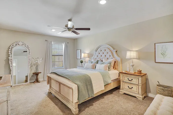 Inviting bedroom with plush, tufted headboard, elegant decor, and warm, neutral tones creating a cozy retreat.