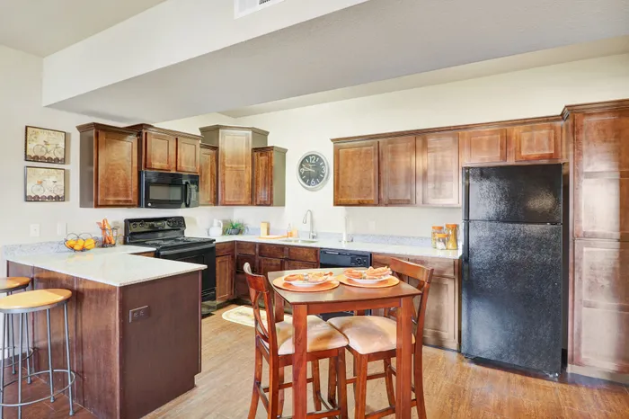 Charming kitchen with modern appliances, elegant wooden cabinetry, and a cozy dining area for gatherings.