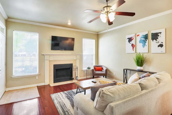 Inviting living room with elegant fireplace, modern decor, and a cozy seating area perfect for relaxation.