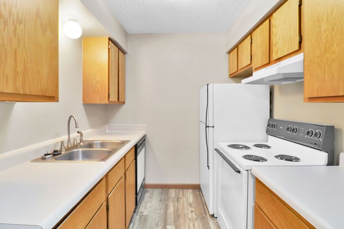 Charming kitchen with modern appliances, sleek countertops, and warm wood cabinetry, perfect for culinary adventures.