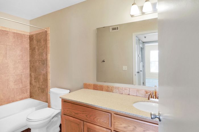 Bright and modern bathroom with sleek fixtures, elegant tilework, and a spacious vanity. Perfect blend of style and functionality.