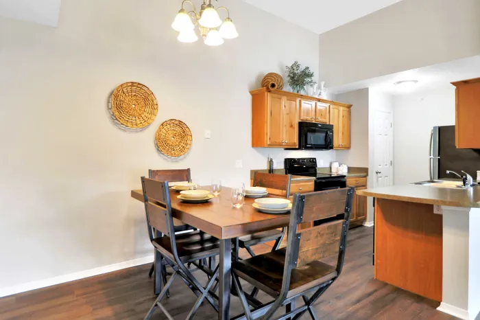 Inviting kitchen and dining area with wooden accents, modern appliances, and rustic charm. Ideal for cozy gatherings.