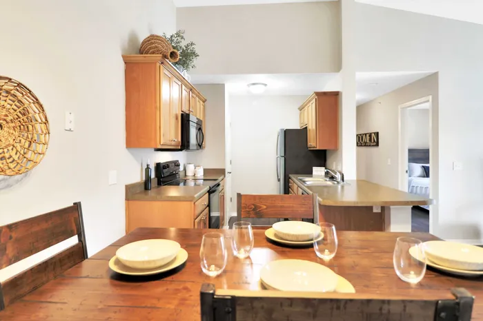 Charming open-concept kitchen with elegant wood cabinetry and a cozy dining area, creating a welcoming family space.
