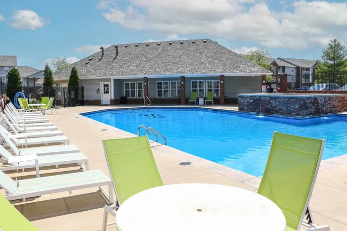Inviting outdoor pool area with modern lounge chairs and sun-kissed patio perfect for relaxation and leisure.