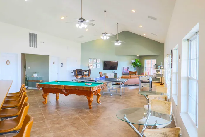 Bright and inviting common area with pool table, ping pong, and cozy seating perfect for social gatherings.