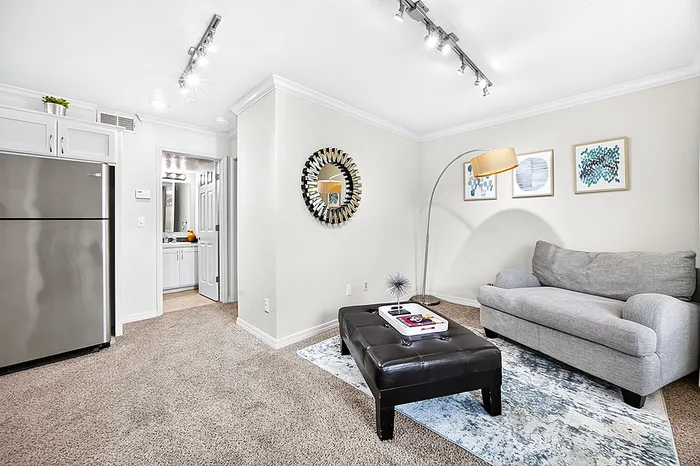 Bright and modern living area featuring stylish decor, cozy seating, and sleek contemporary lighting.