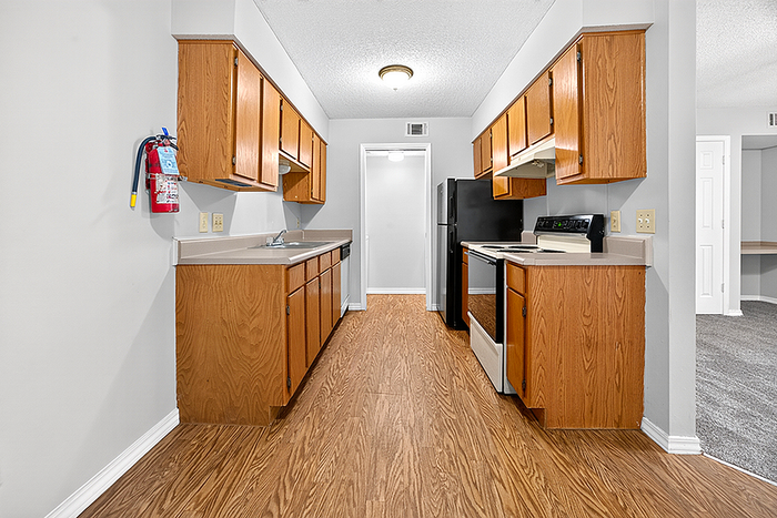 Modern kitchen with sleek wooden cabinetry, stainless steel appliances, and a clean, open layout.