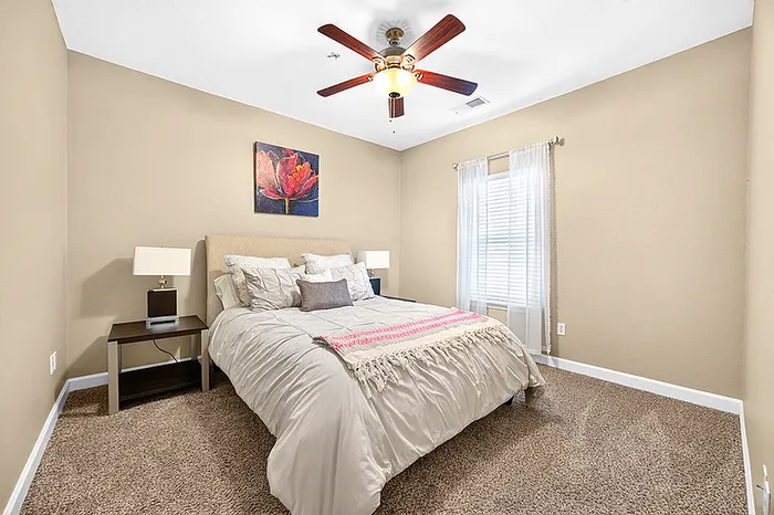 Cozy bedroom featuring a comfortable bed, elegant bedside tables, and charming wall art in a softly lit ambiance.