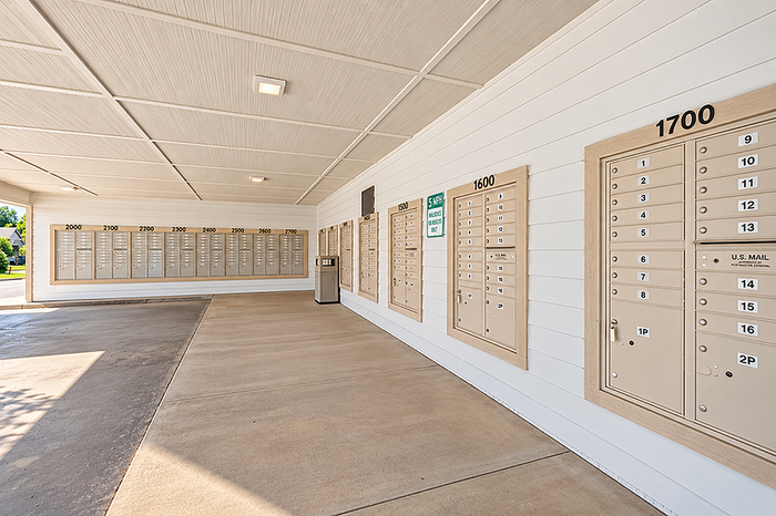 Modern apartment complex featuring a spacious and organized mailroom with numbered mailboxes, ensuring convenient and efficient mail collection.