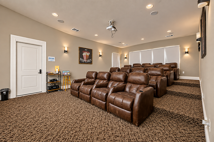 Luxurious home theater with plush leather recliners, ambient lighting, and a state-of-the-art projector for ultimate movie experiences.