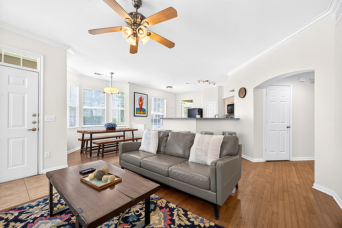 Modern open-concept living room with cozy seating, stylish dining area, and elegant lighting, perfect for entertaining.