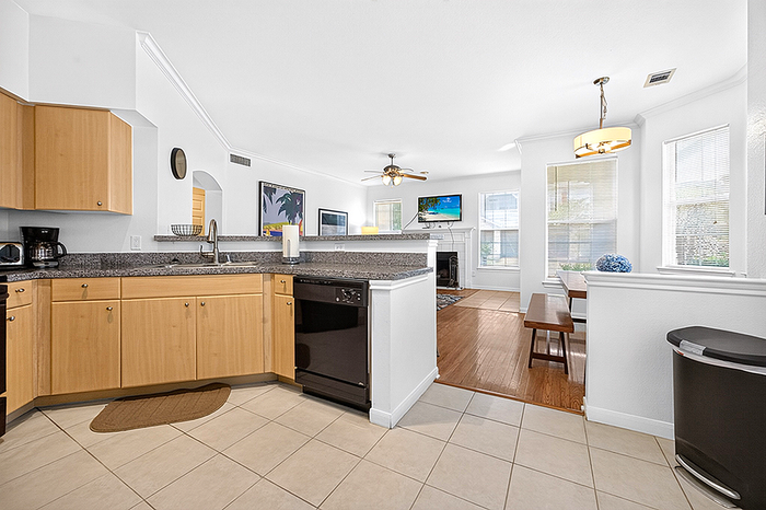 Bright open-concept kitchen and living space with modern appliances, elegant countertops, and inviting dining area.