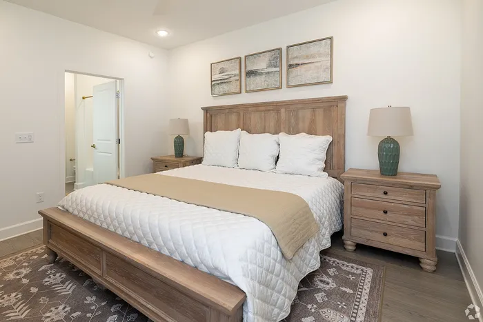 Inviting bedroom with elegant wooden furniture showcasing a plush bed, soft lighting, and tasteful decor.