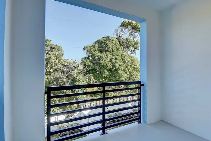 Serene balcony view with lush greenery, perfect for relaxation and enjoying nature.
