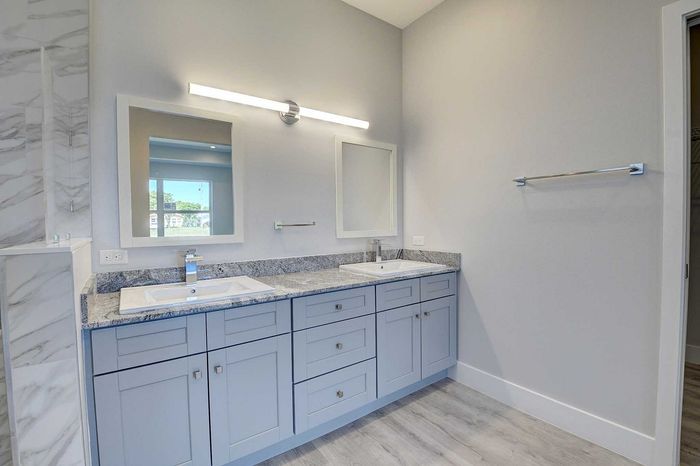 Elegant bathroom with dual sinks, modern fixtures, and sleek marble accents for a luxurious touch.