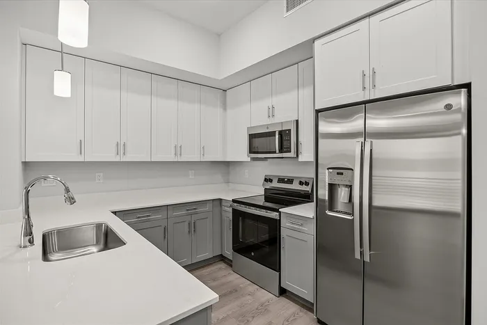 Modern kitchen with sleek stainless steel appliances, elegant cabinetry, and spacious countertops.