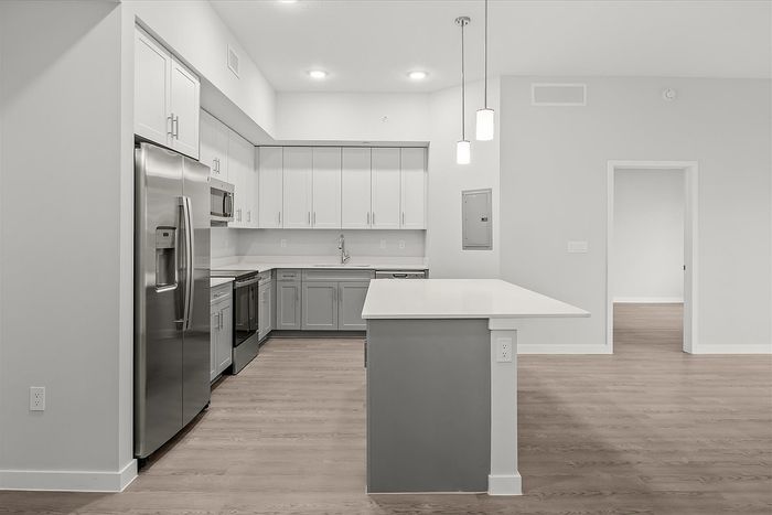 Modern kitchen with sleek stainless steel appliances, elegant cabinetry, and a spacious island countertop.