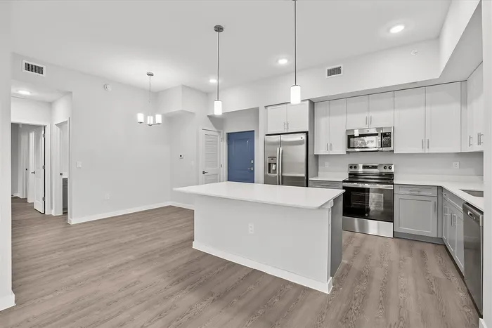 Modern kitchen with sleek cabinetry, stainless steel appliances, and a spacious island, offering an inviting and functional environment.