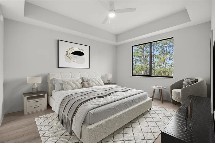 Inviting bedroom with plush bed, modern art, and scenic window view, blending comfort and style.