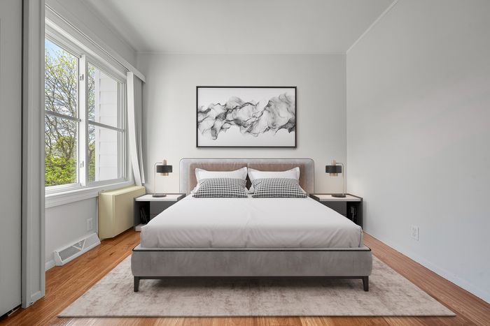 Bright and modern bedroom featuring a comfortable bed, elegant artwork, large window with natural light, and stylish bedside tables.