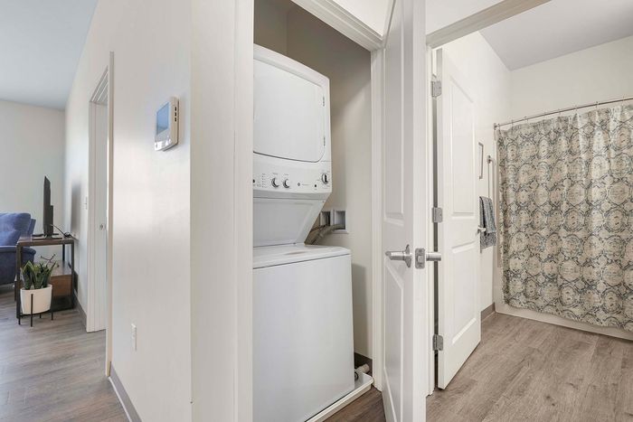 Charming apartment with in-unit laundry, elegant bathroom, and cozy living space, perfect for comfort and convenience.