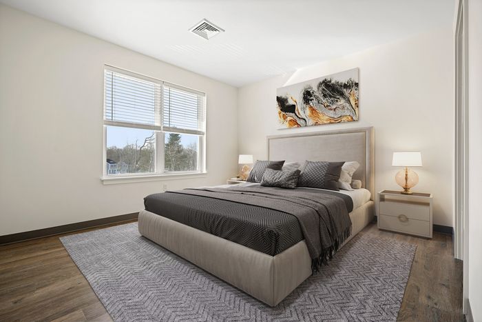 Elegant bedroom with a large window, modern artwork, and stylish decor creating a serene and inviting atmosphere.
