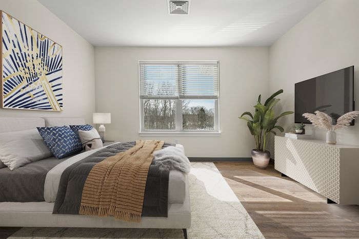 Bright and inviting bedroom with modern decor, featuring a cozy bed, stylish artwork, and a large window with serene views.
