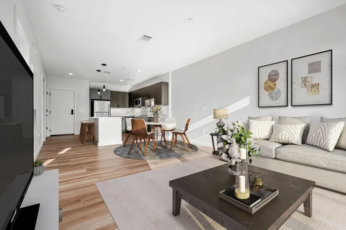 Bright and modern open-concept living space featuring a sleek kitchen, stylish dining area, and cozy living room with elegant decor.