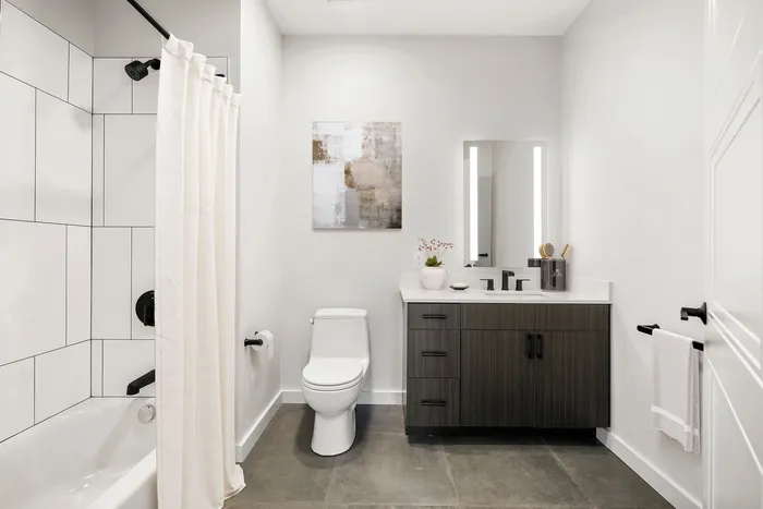 Modern bathroom with sleek tile, elegant vanity, and stylish fixtures for a luxurious feel.