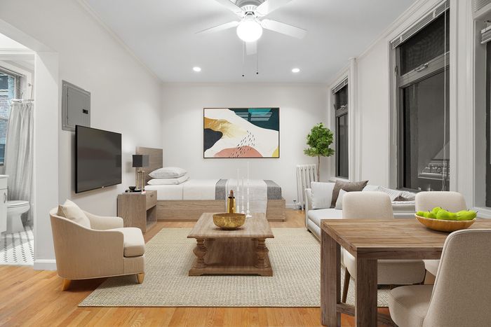 Elegant studio apartment with modern decor, featuring a cozy sleeping area, stylish seating, and a charming dining table, complemented by large windows and natural light.
